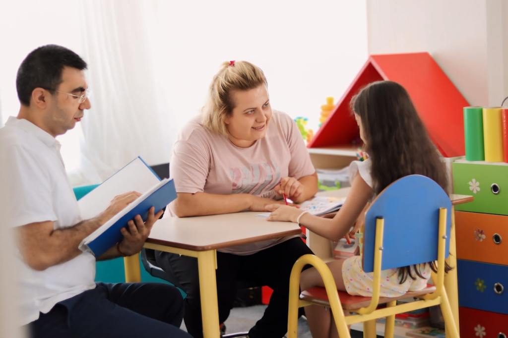 Children at a clean, bright preschool classroom