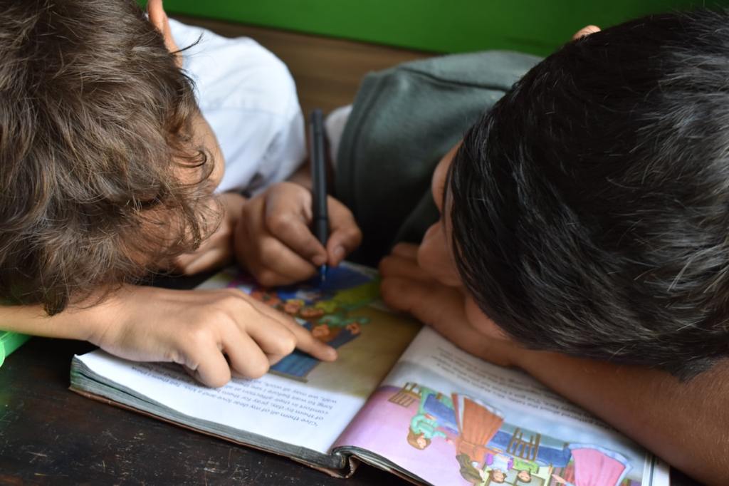 Children at a clean, bright preschool classroom